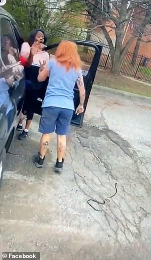 One of the women continues abusing the USPS woman as she gets back in her car