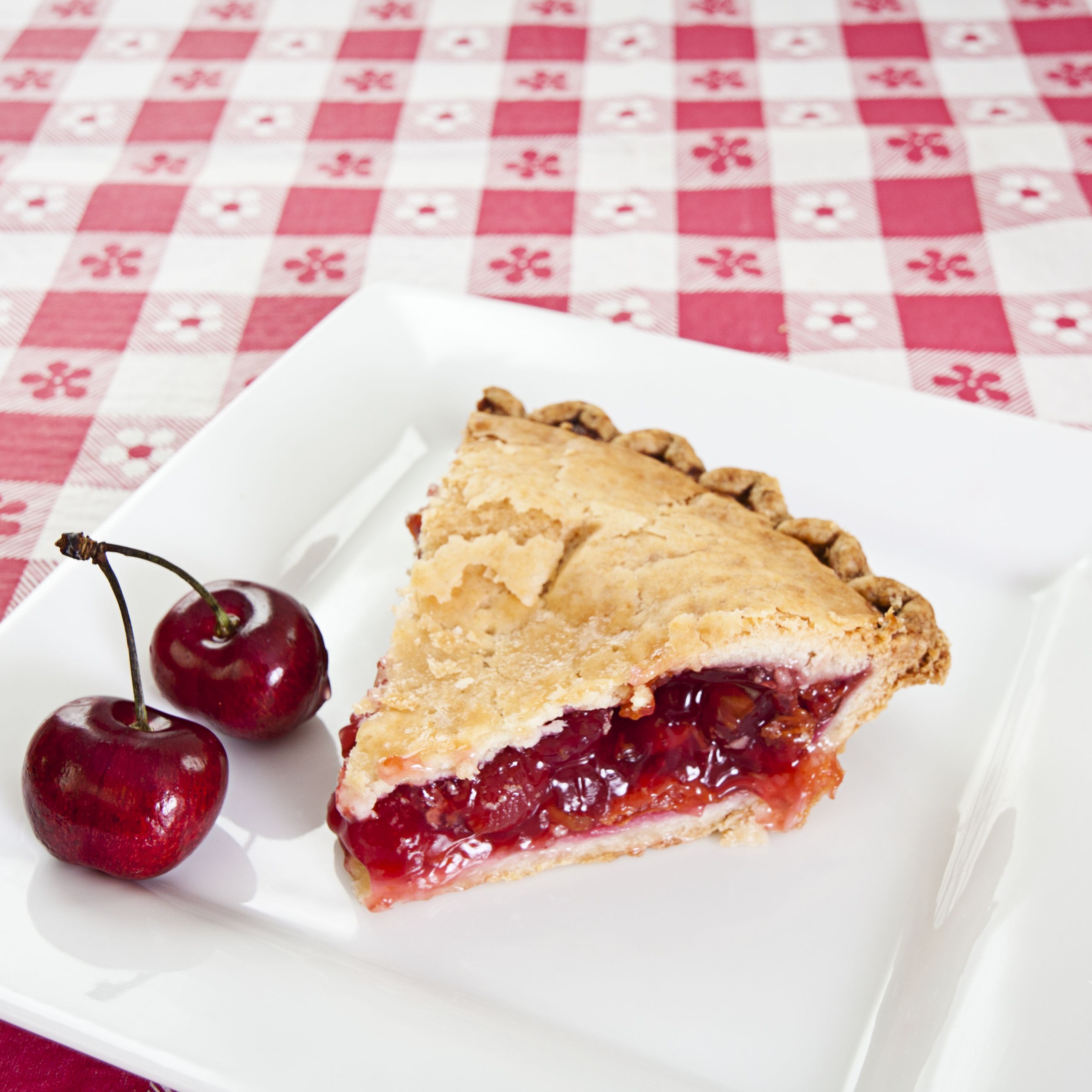slice-of-cherry-pie-with-cherry-on-side-on-plate-169960522-67fcb3cdc8024ea48f2f5a8cd3d2fd8c.jpg