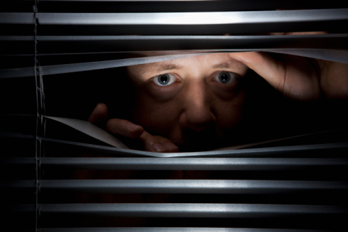 man-peeking-through-blinds-picture-id103405737