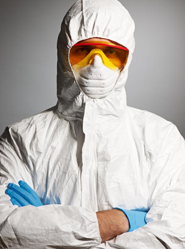 man-wearing-white-protective-suit-gloves-mask-and-goggles.jpg