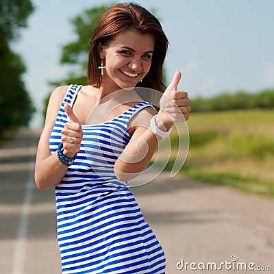 thumbs-up-happy-beautiful-woman-outdoors-25514625.jpg