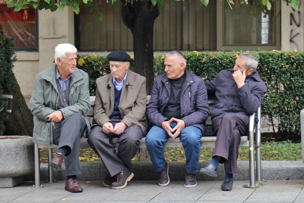 Old-men-sit-on-bench-on-Mother-Teresa-Boulevard-Prishtina-Kosovo.jpg